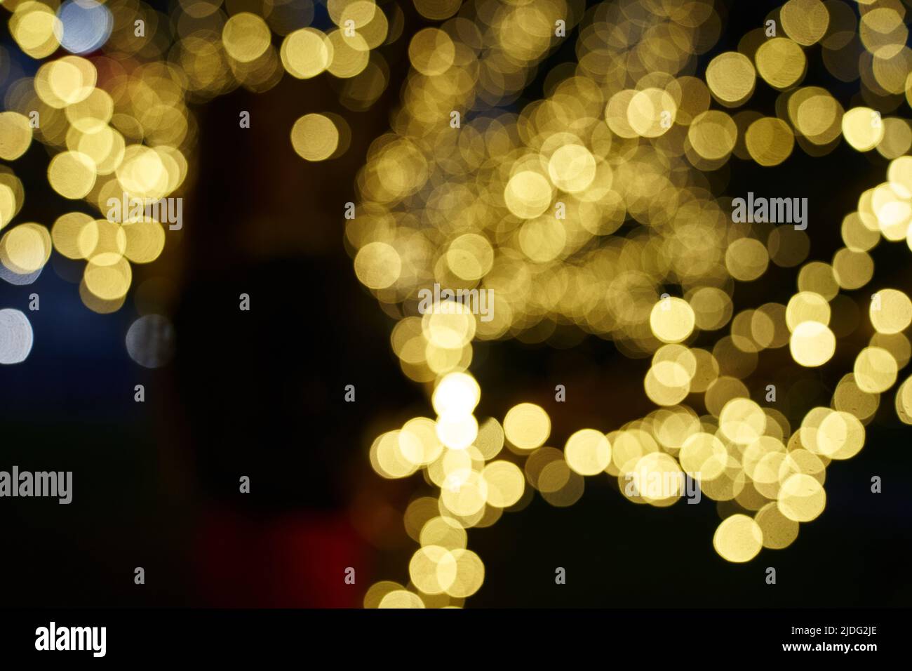Abstrakt leuchtende Bokeh-Lichter auf schwarzem Hintergrund hervorgehoben. Festlicher goldener, leuchtender Hintergrund mit gelben Lichtern. Overlay Bokeh für Ihr Design. Hochwertige Fotos Stockfoto