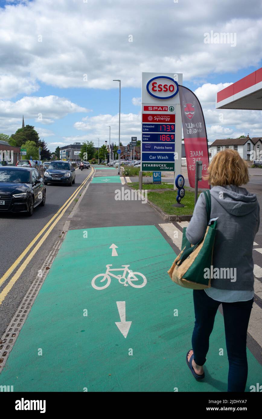 Esso-Tankstelle und Fahrradstraße, die an der A36 Salisbury Wiltshire UK vorbeiführt, zeigt Frauen, die am Verkehr vorbeigehen, und die Tankstelle auf der Fahrradstraße. Stockfoto