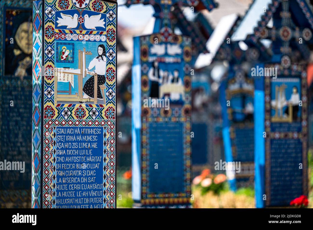 Sapanta, Maramures, Rumänien - 17. Juni 2022: Bemalte blaue Holzdenkmäler in einem einzigartigen in der Welt 'Merry Cemetery'. Stockfoto