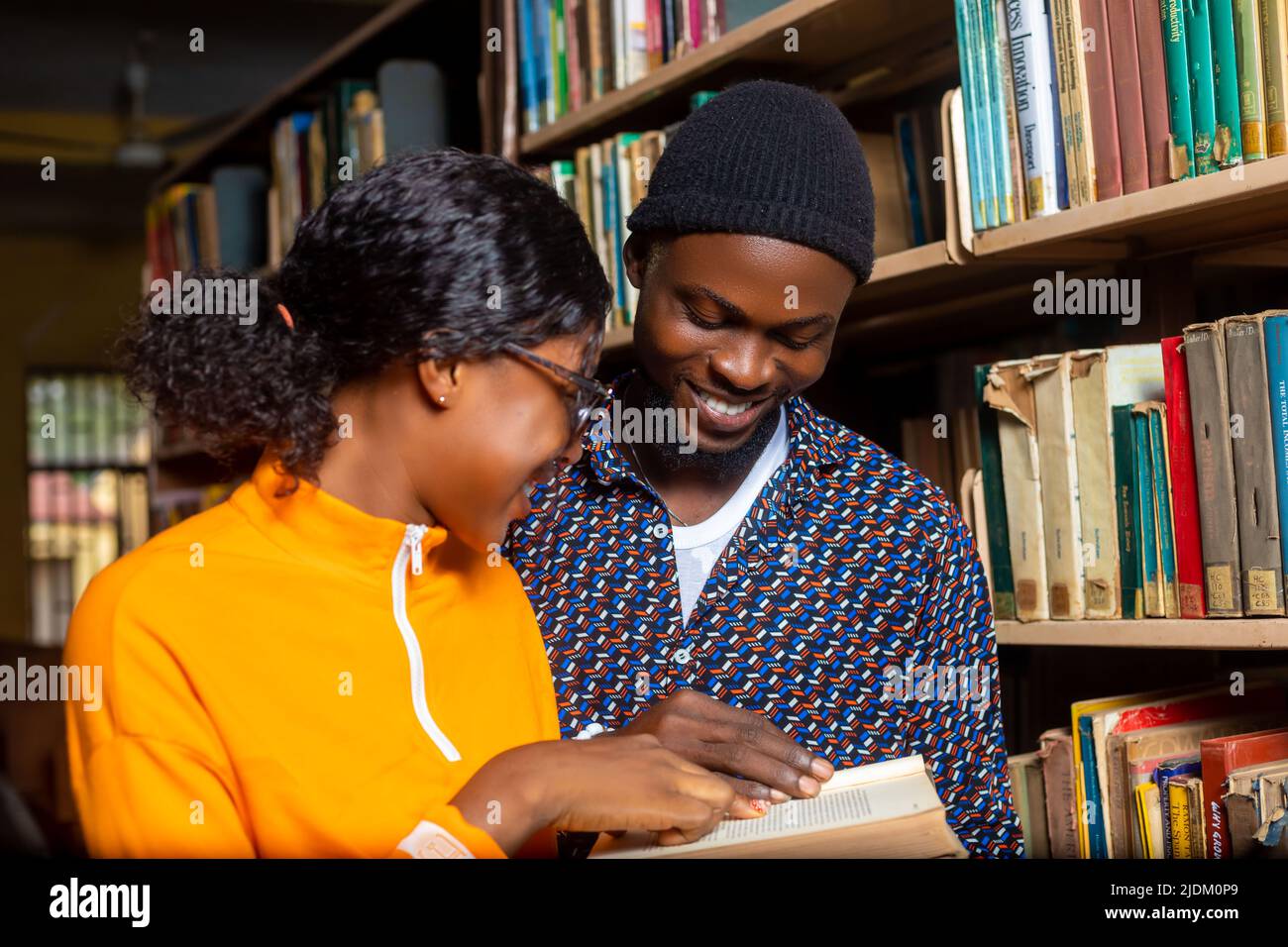 Begeisterte Schüler in der Bibliothek lesen Stockfoto