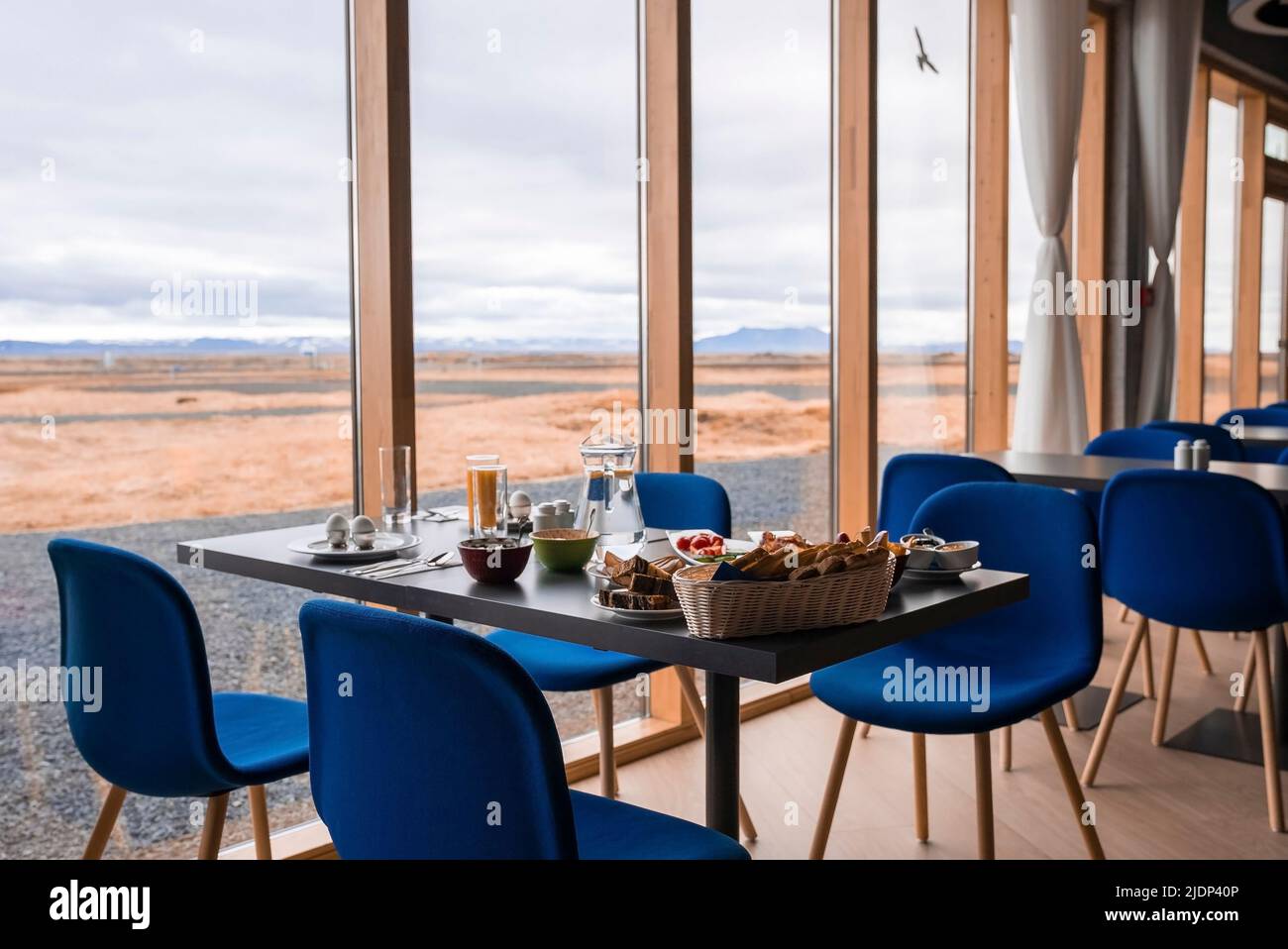 Gesundes Frühstück wird am Esstisch am Glasfenster im luxuriösen Resort serviert Stockfoto