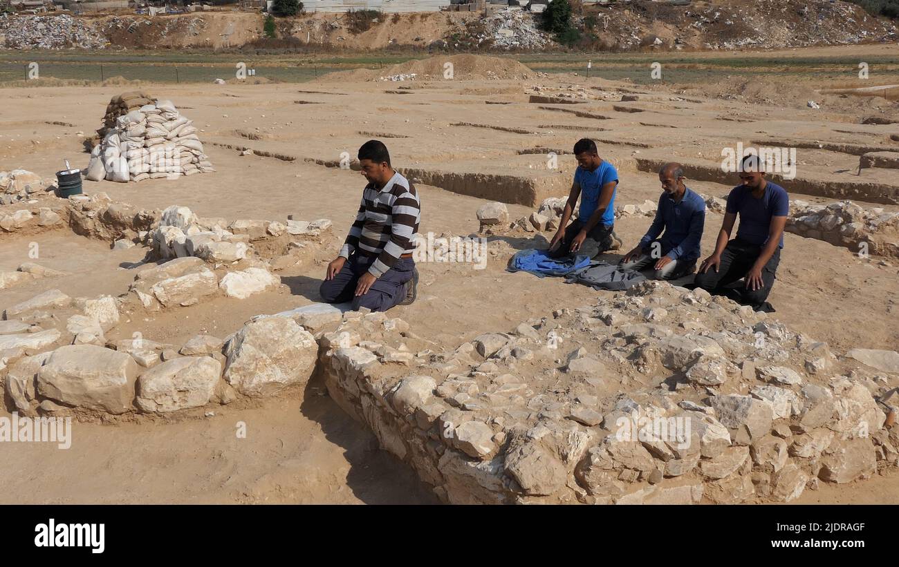 RAHAT, ISRAEL - 22. JUNI: Palästinensische Arbeiter der israelischen Antikenbehörde beten am 22. Juni 2022 in Rahat, Israel, inmitten der Überreste einer kürzlich entdeckten Moschee, die zu den ältesten weltweit bekannten (über 1200 Jahre alt) gehört. Große archäologische Ausgrabungen, die von Israel im Rahmen eines Plans zur Erweiterung der Beduinenstadt Rahat durchgeführt wurden, liefern grafische Details des religiösen Übergangs vom Christentum zum Islam im siebten bis neunten Jahrhundert. Kredit: Eddie Gerald/Alamy Live Nachrichten Stockfoto
