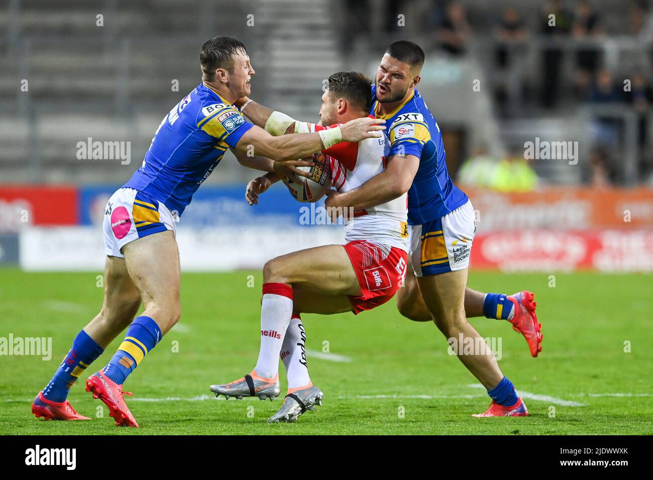 Tommy Makinson #2 aus St. Helens wird von James Bentley (11) und Harry Newman (3) aus Leeds Rhinos angegangen Stockfoto