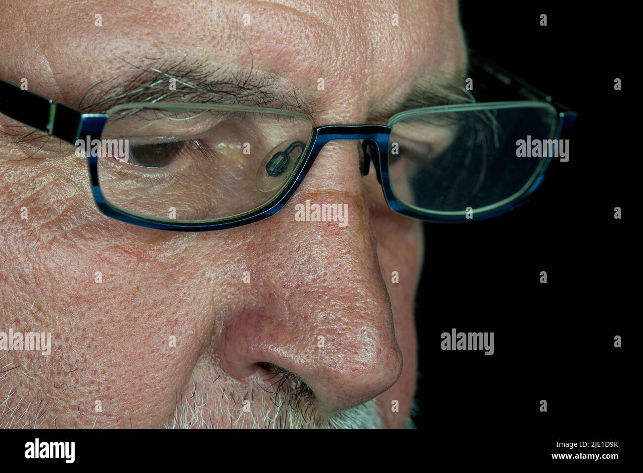 Gesichtsdetail eines alten Mannes mit Brille. Presbyopie erschwert das Lesen ohne Brille in der zweiten Lebenshälfte. Stockfoto