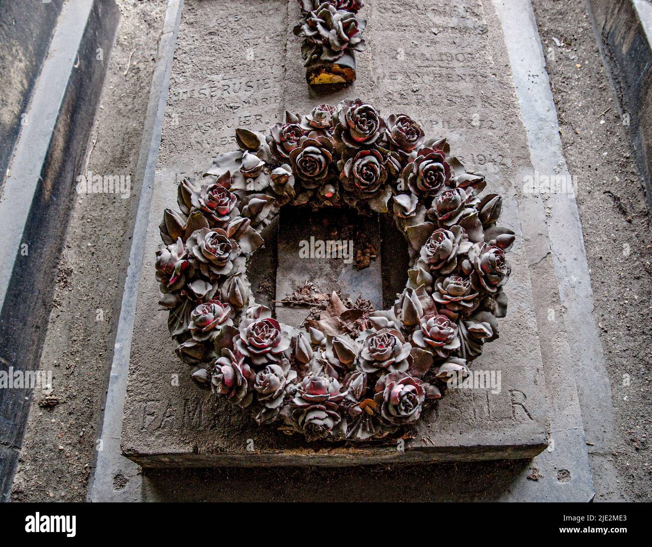 Blumenkranz auf einem Familiengrab auf dem Friedhof von Montmartre. Paris, Frankreich. 05/2009 Stockfoto