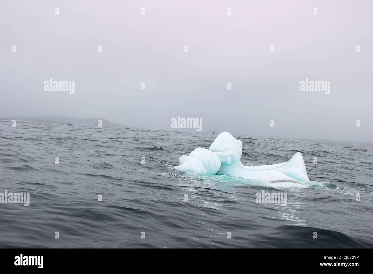 Welle krachend gegen kleine Eisberge, die im Meer schweben Stockfoto