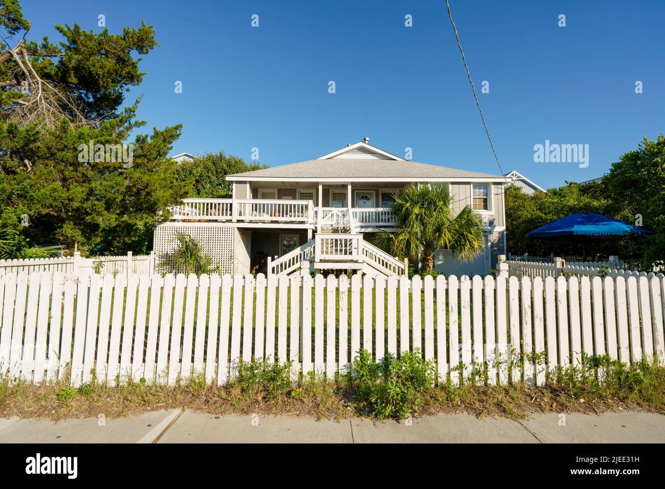 Foto eines einzigen Familienhauses mit weißem Pfostenzaun in Wrightsville North Carolina in der Nähe des Strandes Stockfoto