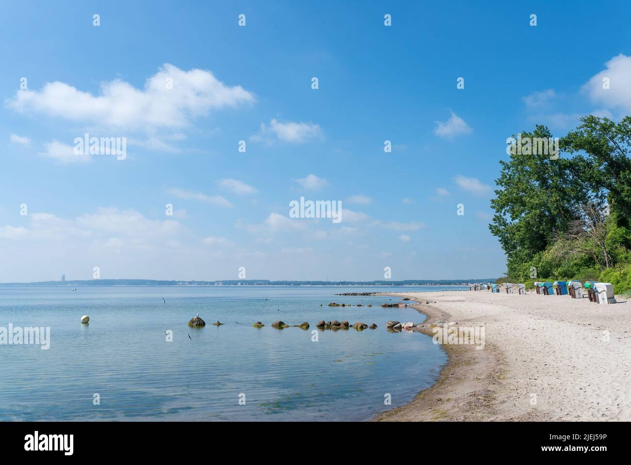 Traditionelle Strandliegen am ostseestrand vor blauem Himmel am sonnigen Sommertag Stockfoto