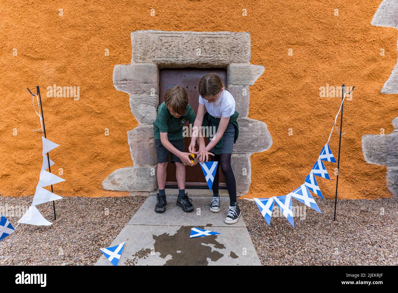 Athelstaneford, East Lothian, Schottland, Großbritannien, 27.. Juni 2022. Wiedereröffnung des National Flag Heritage Centre: Das Hepburn Doocot wurde in den letzten 3 Monaten renoviert und mit £98.000 Mitteln von Historic Environment Scotland, East Lothian Council & Other Trusts finanziert. Im Bild: Oliver und Katy, Schüler der Athelstaneford Primary School, schnitten das Band Stockfoto