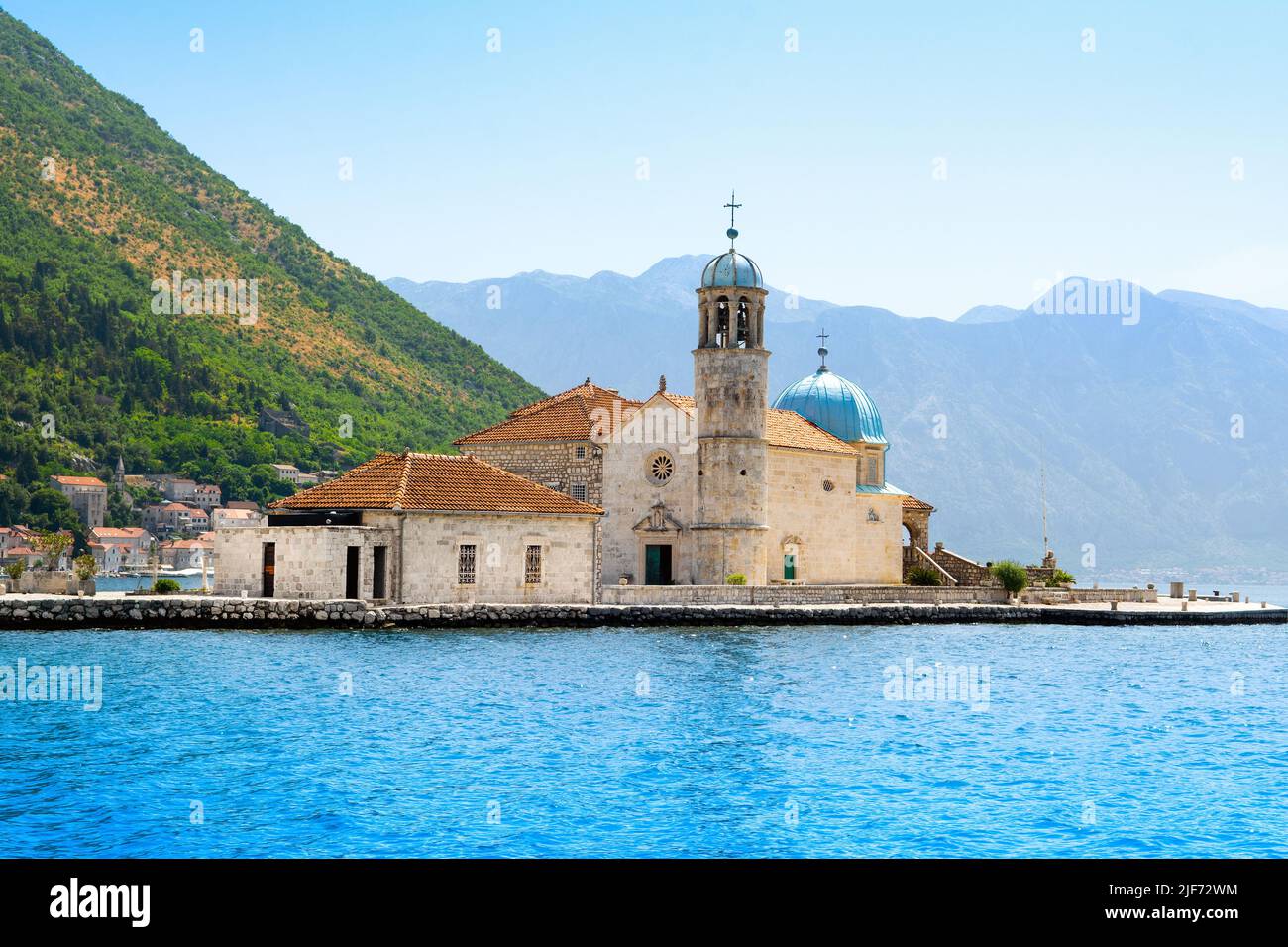 Landschaft der Bucht von Kotor Küste - Boka Bucht mit Blick auf die römisch-katholische Kirche unserer Lieben Frau von den Felsen, Montenegro Stockfoto