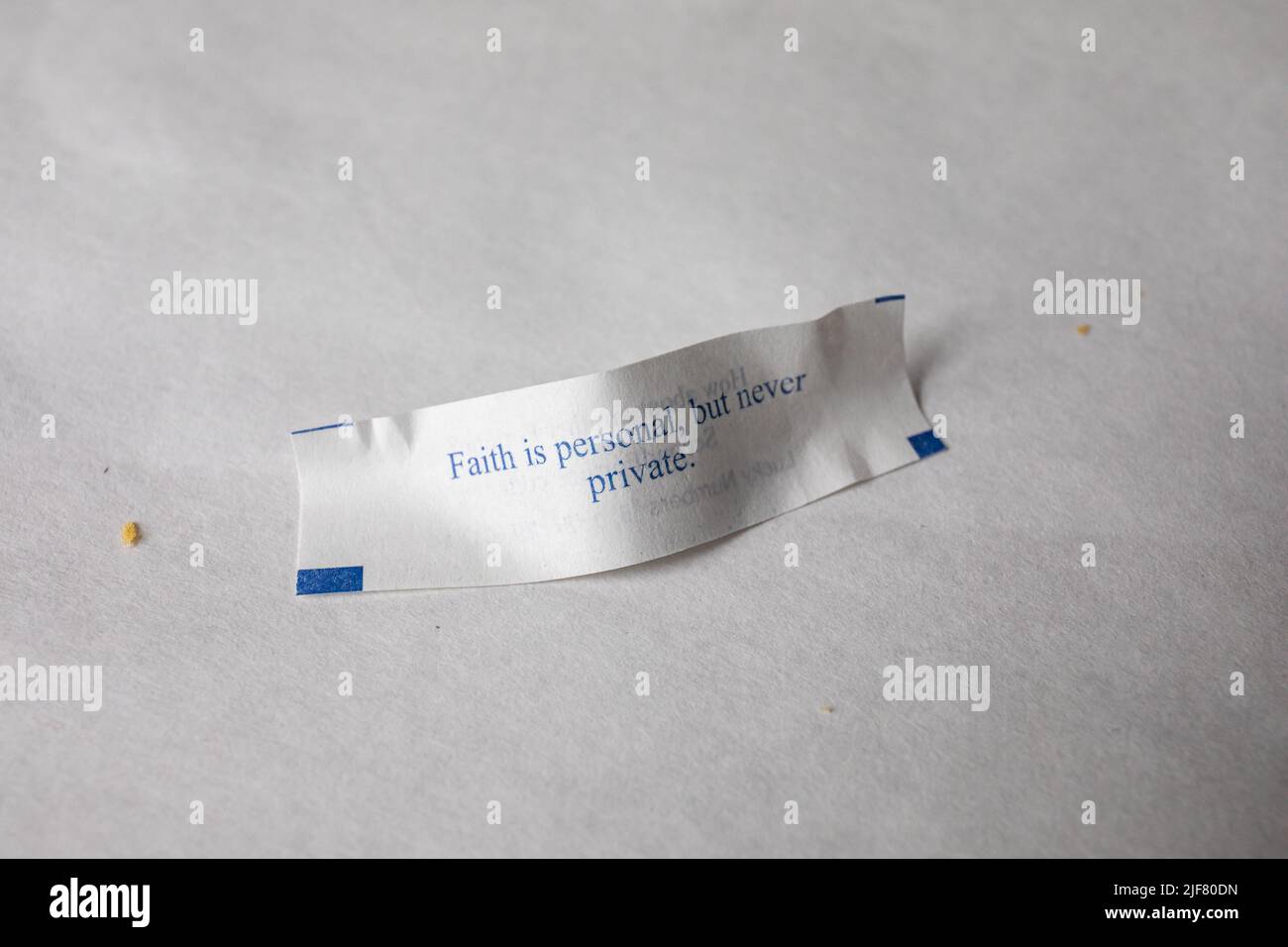 Der Glaube ist persönlich, aber nie privat. Glückskekiechensage auf chinesischem Restauranttisch. Stockfoto