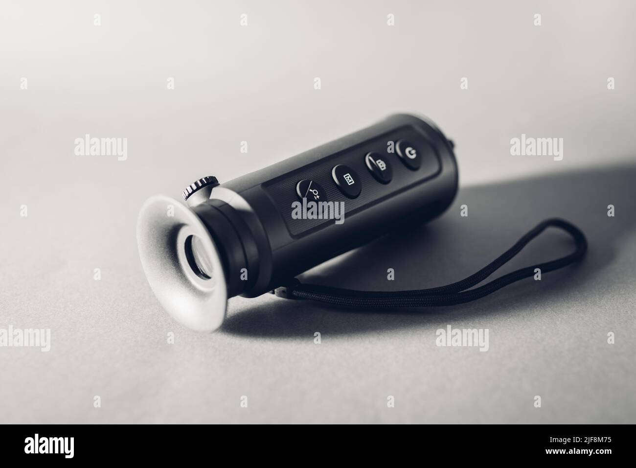 Nachtsichtgerät monokular. Wärmebildkamera auf grauem Hintergrund. Handheld-Gerät zum Wandern, Reisen und Jagen Stockfoto
