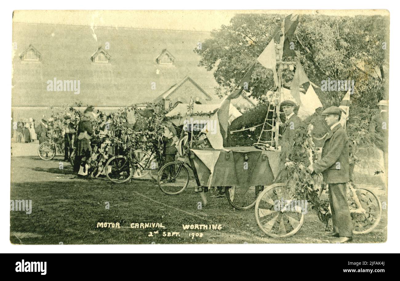 Original-Postkarte aus der Zeit Edwardians von einem Motorkarneval. Die Teilnehmer haben ihre Fahrräder mit Fahnen der patriotischen Union Jack dekoriert, ein Fahrrad wurde in ein Schiff verwandelt, Church of St. Francis, West Worthing, Sussex, England, UK vom 2. September 1908, Stockfoto