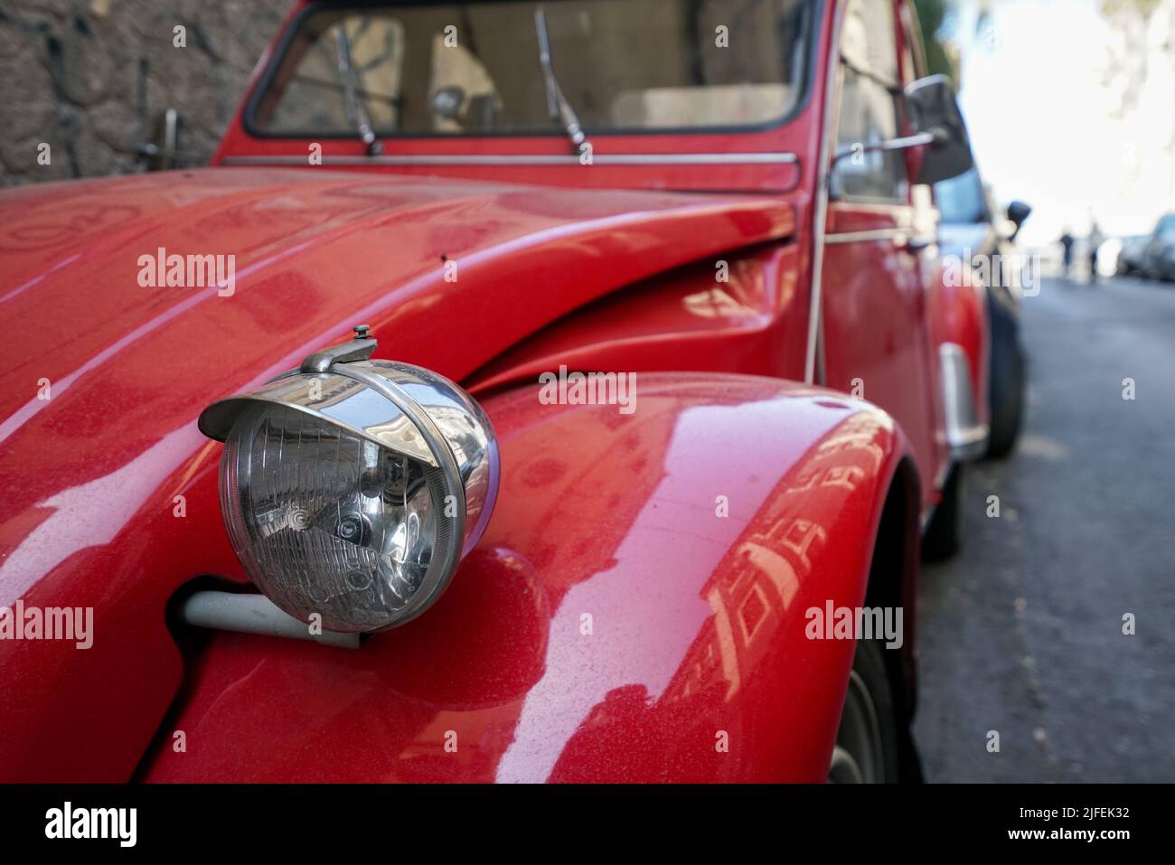 Eine Nahaufnahme eines roten Retro-Autos, das in der Ecke geparkt ist Stockfoto