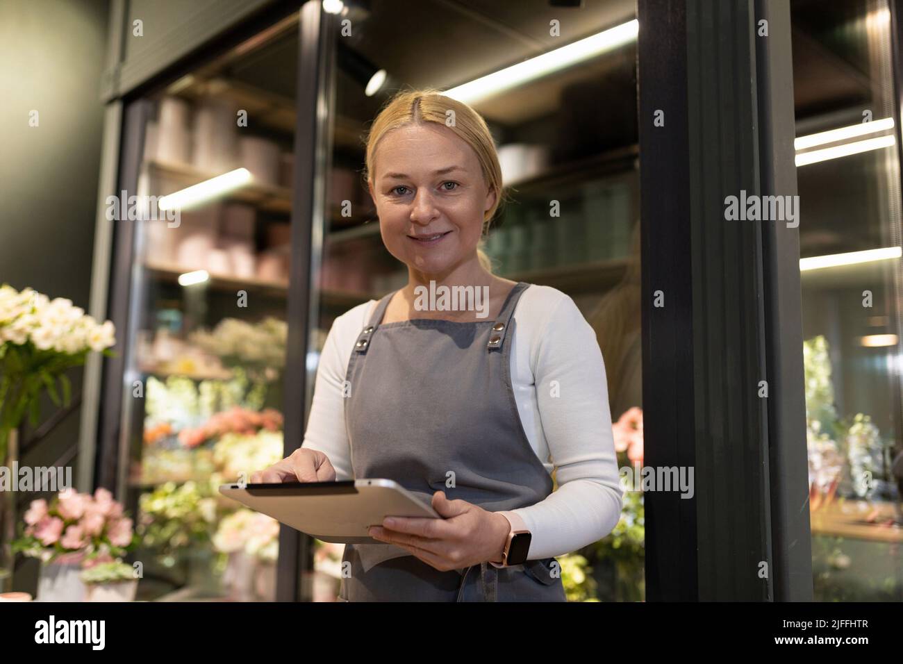 Blumengeschäft Mitarbeiter Inventar mit Zwischenablage in den Händen Stockfoto