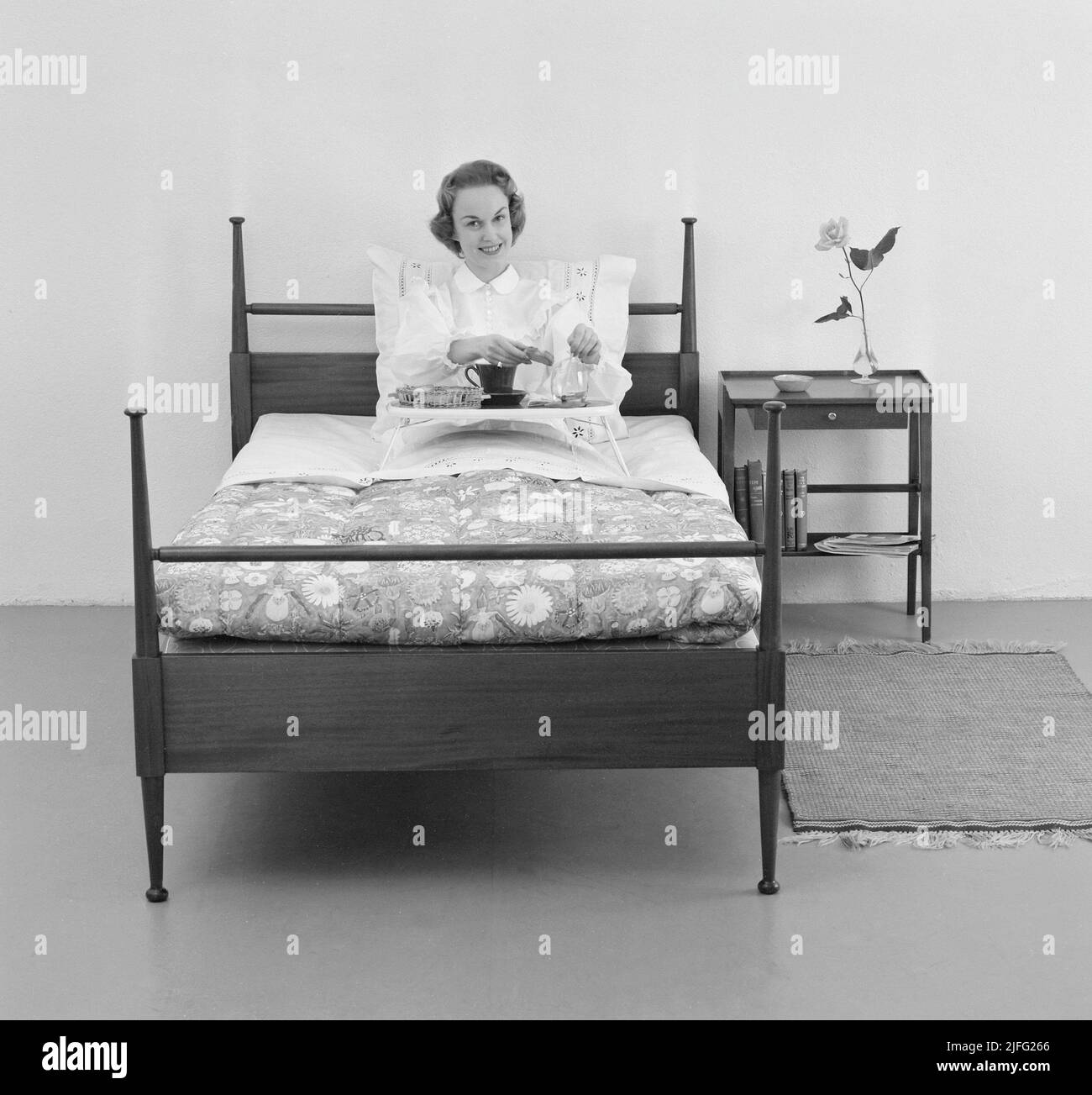 Frau der 1950s. Eine junge Frau im Bett mit Frühstück serviert für sie auf einem Tablett Schweden 1955 Stockfoto
