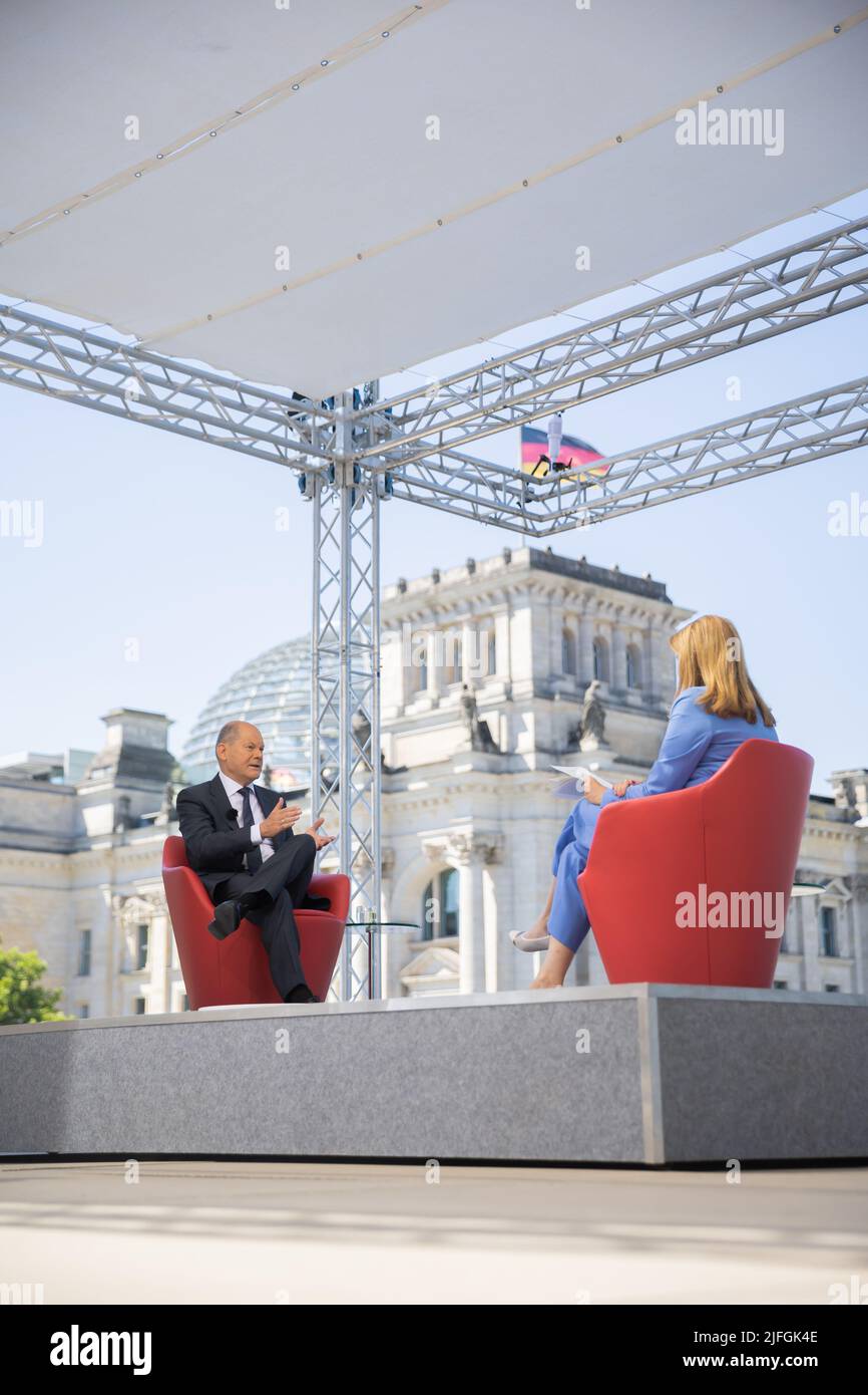 Berlin, Deutschland. 03.. Juli 2022. Bundeskanzler Olaf Scholz (SPD) spricht mit Tina Hassel, der Leiterin des ARD-Hauptstadtstudios, während des Sommerinterviews des ARD-Berichts "Bericht aus Berlin" auf der Terrasse des Marie-Elisabeth-Lüders-Hauses. Quelle: Christoph Soeder/dpa/Alamy Live News Stockfoto