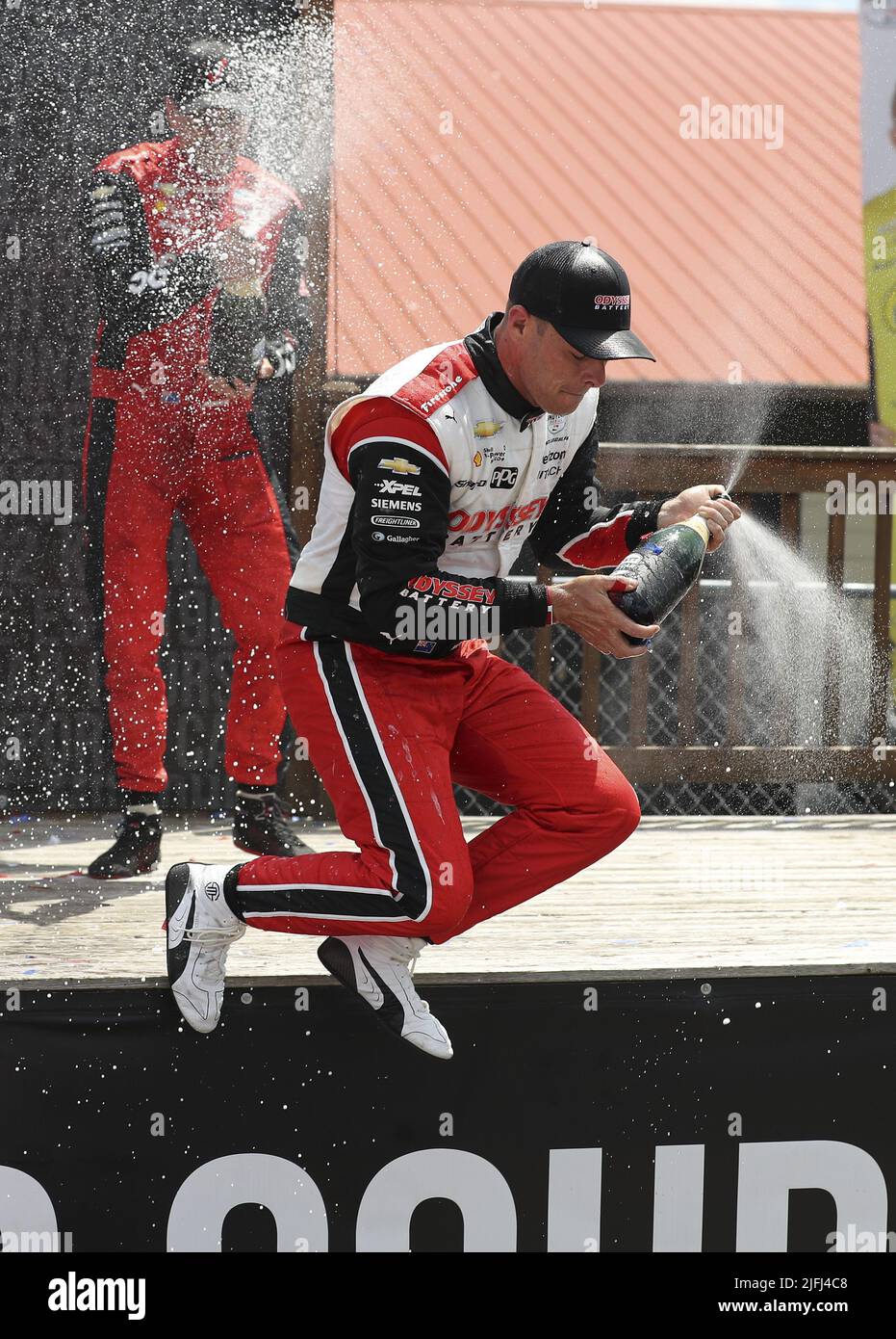 Akron, Usa. 03.. Juli 2022. Scott McLaughlin (3) springt von der Bühne, als er am Sonntag, den 3. Juli 2022, den Sieg der Honda 200 auf dem Mid Ohio Sports Course in Lexington, Ohio, feiert. Foto von Aaron Josefczyk/UPI Credit: UPI/Alamy Live News Stockfoto