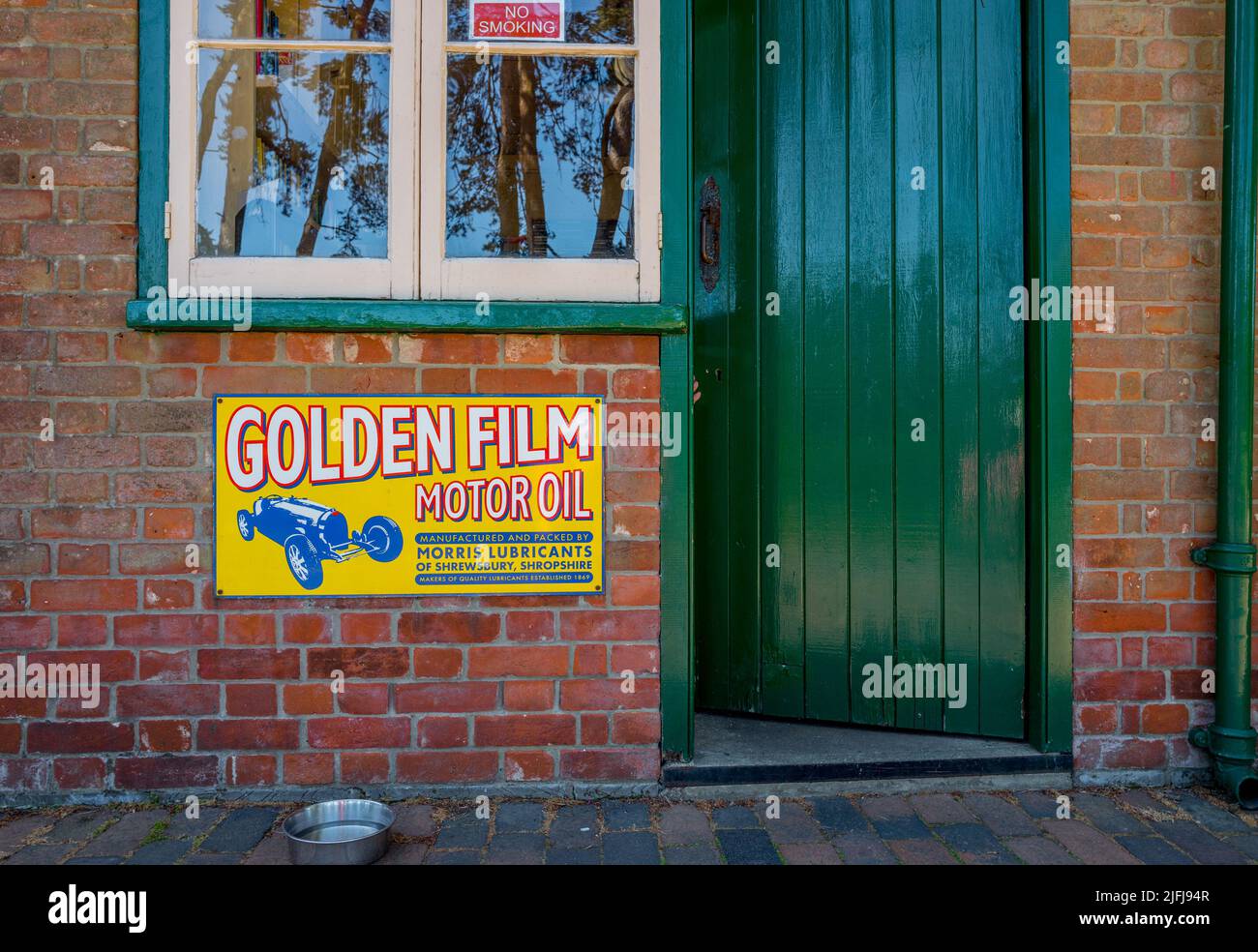 Vintage Morris Schmierstoffe Glodern Film Motoröl Emaille Schild an einem Backsteingebäude am holt Bahnhof Eisenbahnmuseum, holt, Norfolk angebracht Stockfoto
