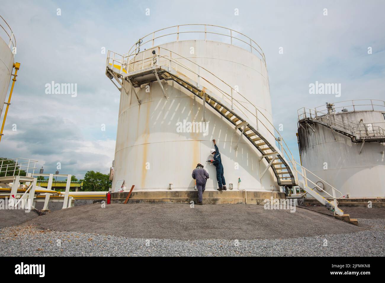 Männlicher zwei-Arbeiter-Inspektionstank von vertikalem Chemikalienbehälteröl der Stärkeplatte. Stockfoto