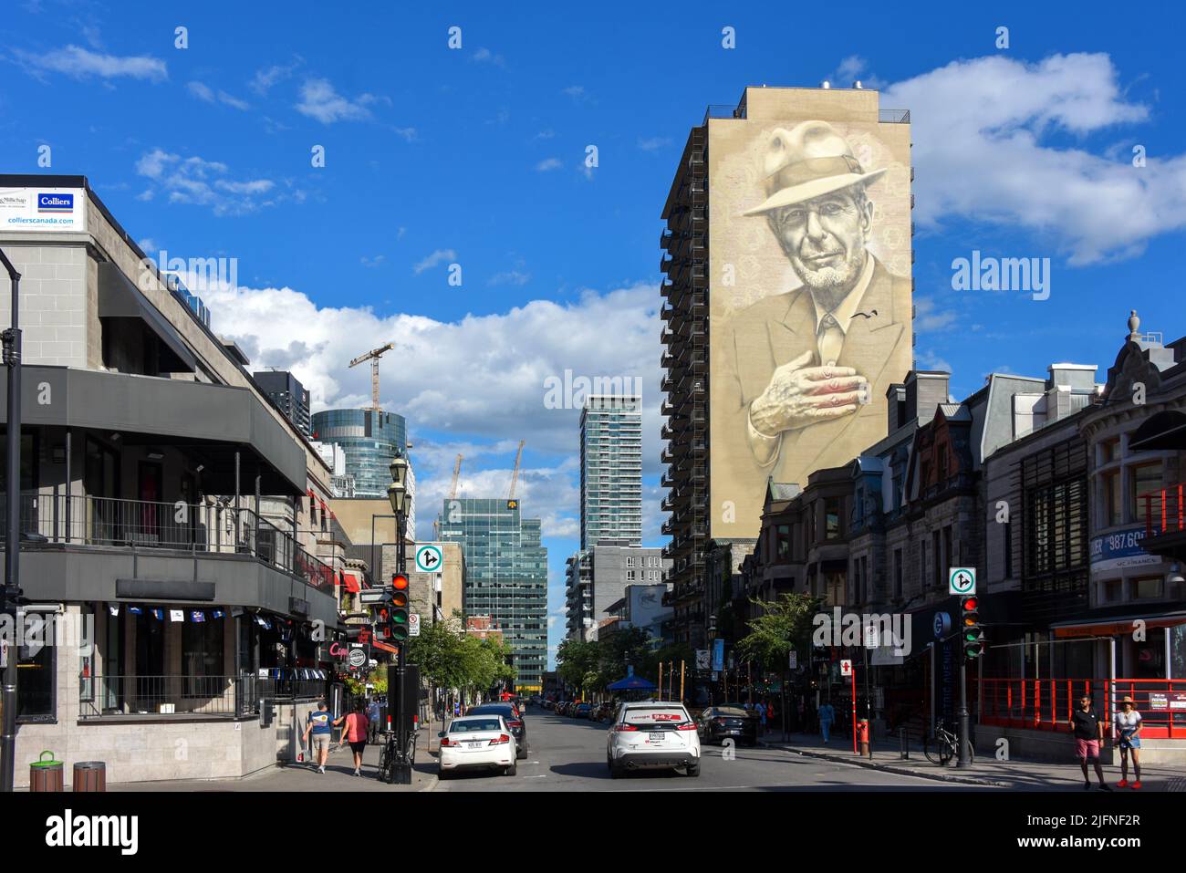 Montreal, Kanada - 3. Juli 2022: Die trendige Crescent Street mit Wandbild des legendären Singer/Songwriters Leonard Cohen an der Seite des Gebäudes. Stockfoto