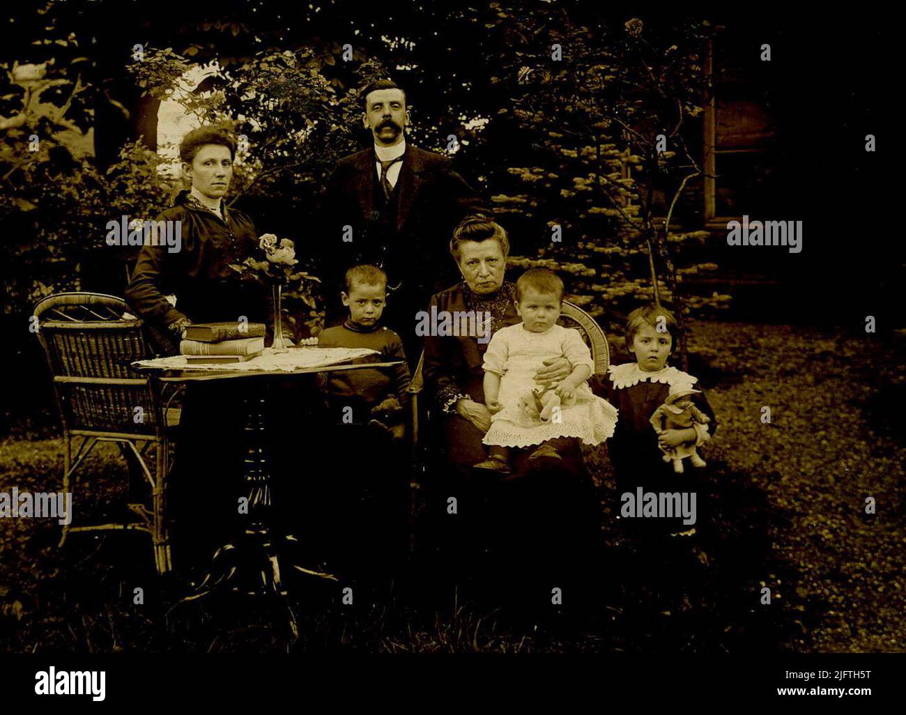 Porträt der Familie Donkers-Verheij. Achter, rechts, Lehrer und Schulleiter, Johannes Hendrikus Marie Donkers (22/08/1878 - 03/11/1966), und links, Ehefrau Wilhelmina Carolina Verheij (19/01/1888 - 19/01/1963). Vor der Tür sitzend (Tante) Johanna Uijen (31/01/1860 - 11/03/1943) und die Kinder Cor (C.Th.J.), Riet (M.E.C-M.) und Dina (M. Stockfoto