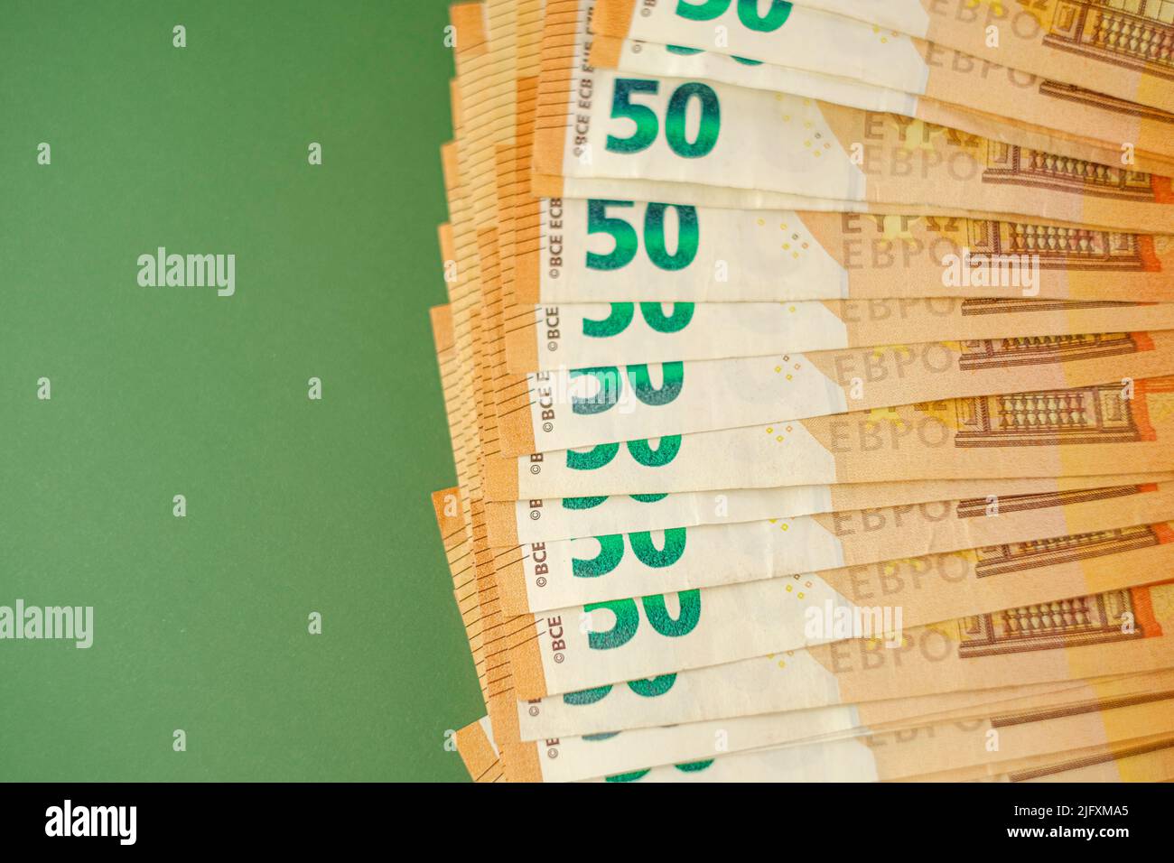 Euro-Banknoten auf grünem Hintergrund.Euro-Währung.Geld und Finanzen. Einkommen in europäischen Ländern.Euro-Währungskurs.Budgetzuweisung Stockfoto