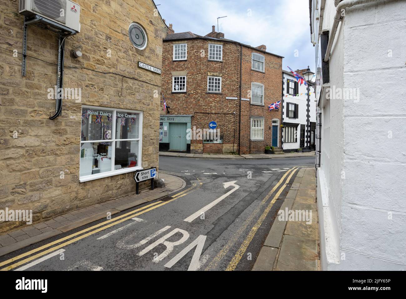 Typische englische Straße in Knaresborough, Yorkshire, mit Pfeil nach links auf der Straße markiert Stockfoto