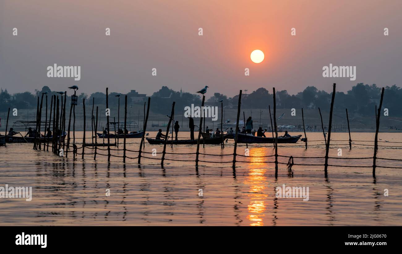 Prayagraj ,13, Januar, 2017:Panoramablick auf die aufgehende Sonne und Boote, die sich in den Gewässern des Flusses Ganga in Sangam, Prayagraj, Uttar Pradesh, Indien, spiegeln Stockfoto