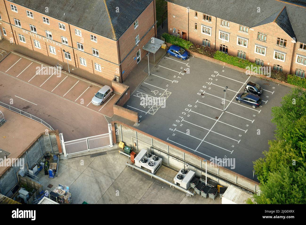 Ein englisches Gesundheitszentrum mit einem fast leeren Parkplatz. Nur ein paar Autos parkten. Stockfoto