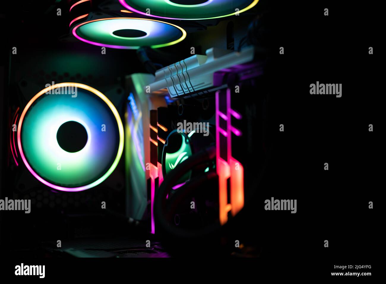 Ein High-End-Gaming-Computer ist mit Regenbogenfarben beleuchtet. Alle Hardwarekomponenten leuchten in verschiedenen Farben. Stockfoto