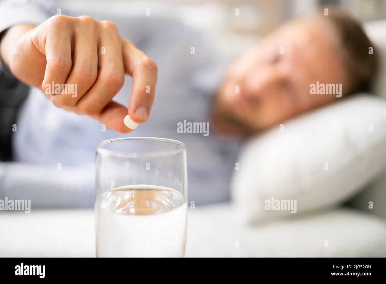 Mann Mit Hangover, Der Die Arzneipille Heilt Stockfoto