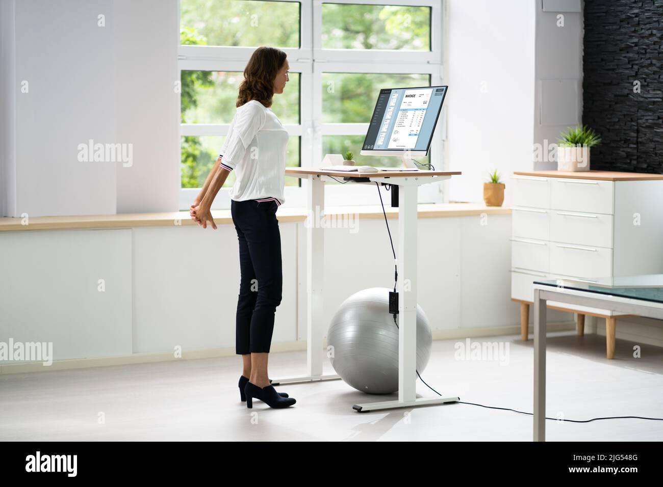 Übung Zum Dehnen Der Mitarbeiter Am Schreibtisch Im Büro Stockfoto