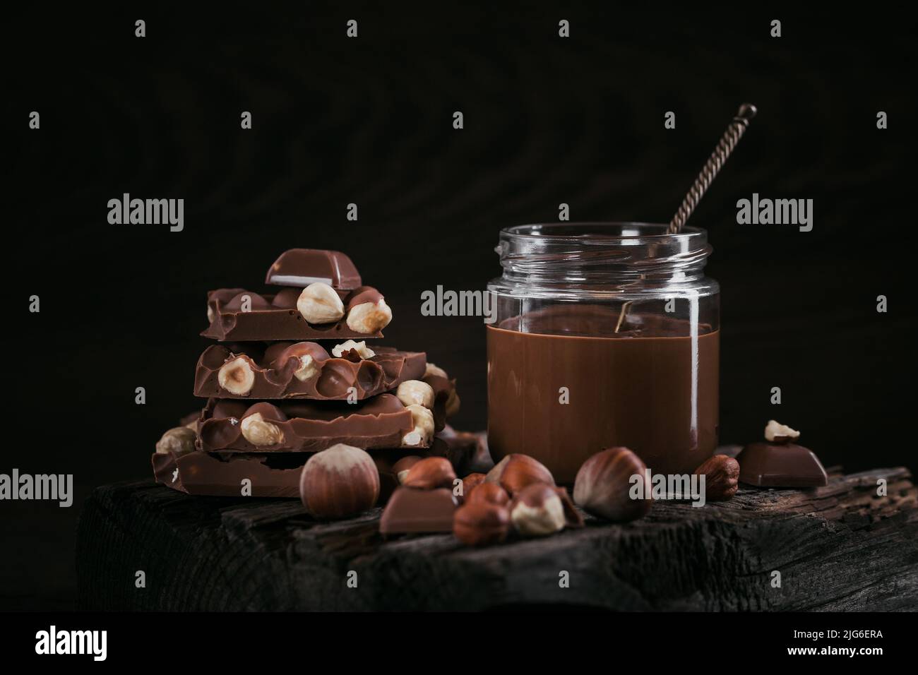 Hausgemachte Schokolade Haselnuss Milch auf einem dunklen Hintergrund verteilt Stockfoto