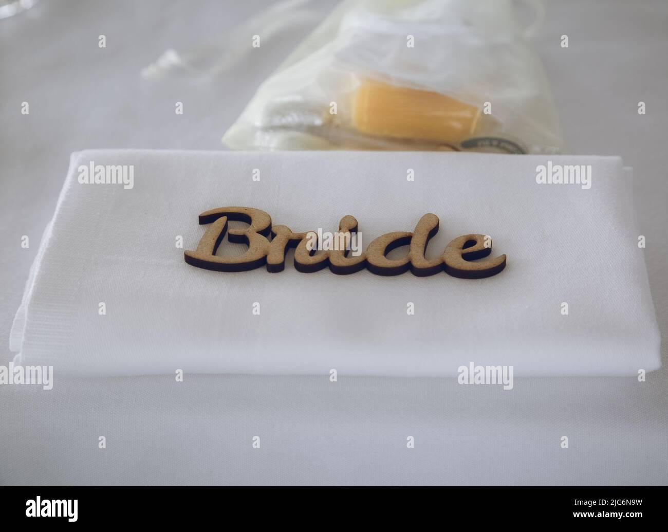 Eine Serviette mit einem Holzplatz, auf dem Braut beim Hochzeitsfrühstück gelesen wird Stockfoto