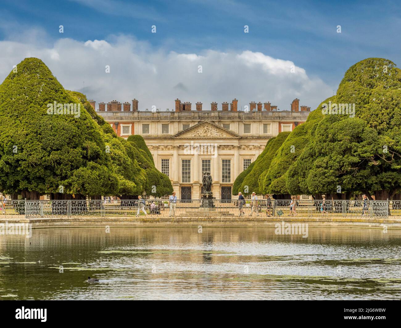 Ostfront des Hampton Court Palace, eingerahmt von den Eibenbäumen des Great Fountain Garden mit dem langen Wasser im Vordergrund. London. VEREINIGTES KÖNIGREICH. Stockfoto