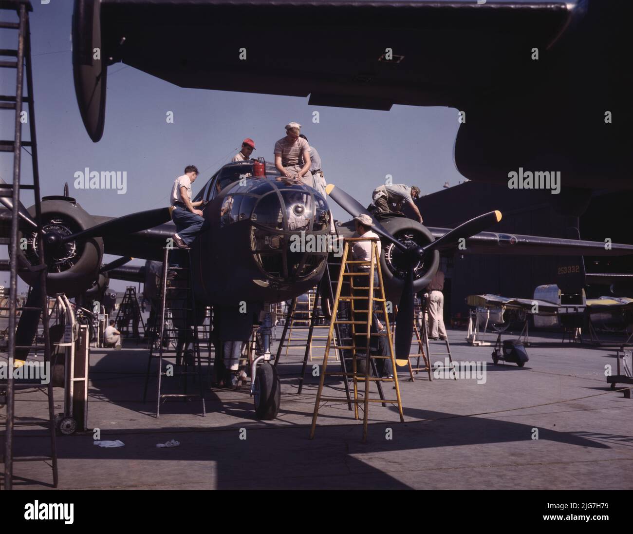 Mitarbeiter der „Sunshine“-Montagelinie im nordamerikanischen Werk haben einen weiteren B-25-Bomber, Inglewood, Kalifornien, in den letzten Schliff gebracht. Zusätzlich zum im Kampf getesteten B-25 („Billy Mitchell“)-Bomber, der bei General Doolittles Überfall auf Tokio eingesetzt wurde, In diesem Werk wird das Kampfflugzeug P-51 ("Mustang") hergestellt, das erstmals durch den britischen Überfall auf Dieppe in den Vordergrund gerückt wurde. Stockfoto