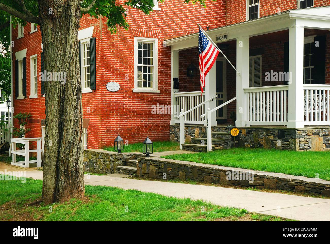 Eine amerikanische Flagge hängt von der Veranda des Hayden Starkey Store, jetzt ein historisches Haus in Essex Connecticut Stockfoto