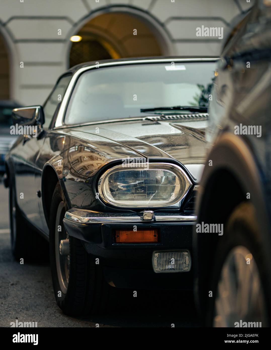 Eine vertikale Aufnahme eines schwarzen Jaguar Autos im Retro-Look Stockfoto
