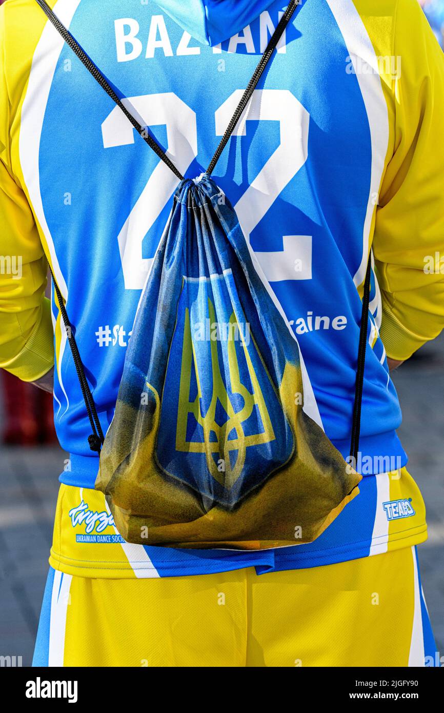 Eine Person, die die Farben der Ukraine trägt, und eine Tasche mit dem Wappen der Ukraine (Tryzub oder Dreizack) auf einer Demonstration in Calgary Stockfoto