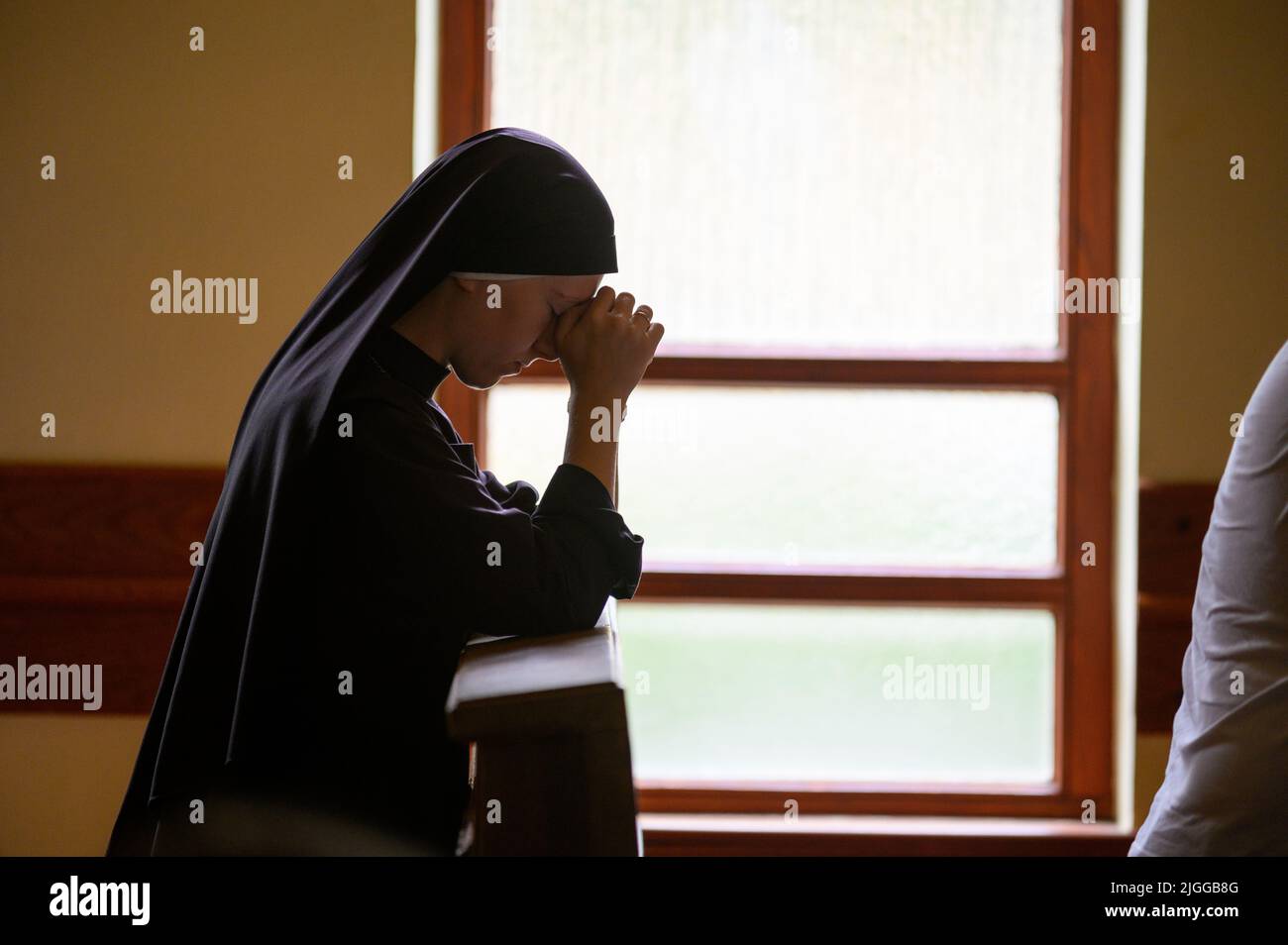 Eine Nonne, die in der Anbetungskapelle in Medjugorje im Gebet verweilt. Stockfoto
