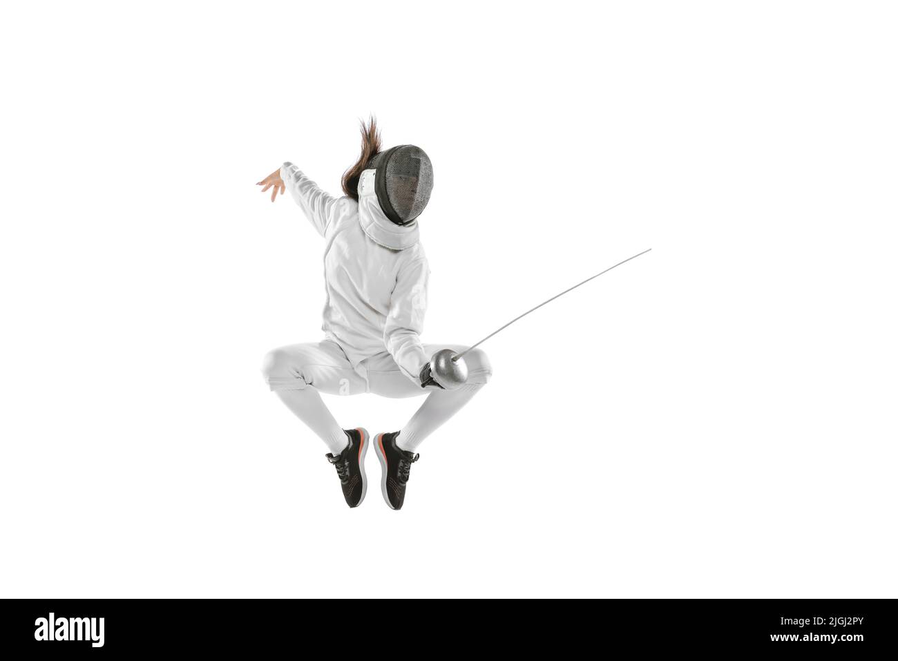 Energischer weiblicher Fechter in weißem Fechtkostüm und Maske in Aktion, Bewegung isoliert auf weißem Hintergrund. Sport, Jugend, Aktivität, Fähigkeiten, Erfolge Stockfoto