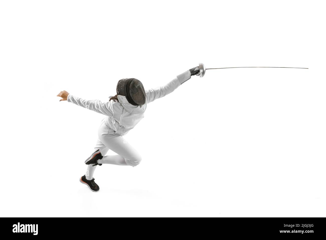 Eine Sporterin, weibliche Fechterin in weißem Fechtkostüm in Aktion, Bewegung isoliert auf weißem Hintergrund. Sport, Jugend, Hobbys, Erfolge, Ziel. Stockfoto