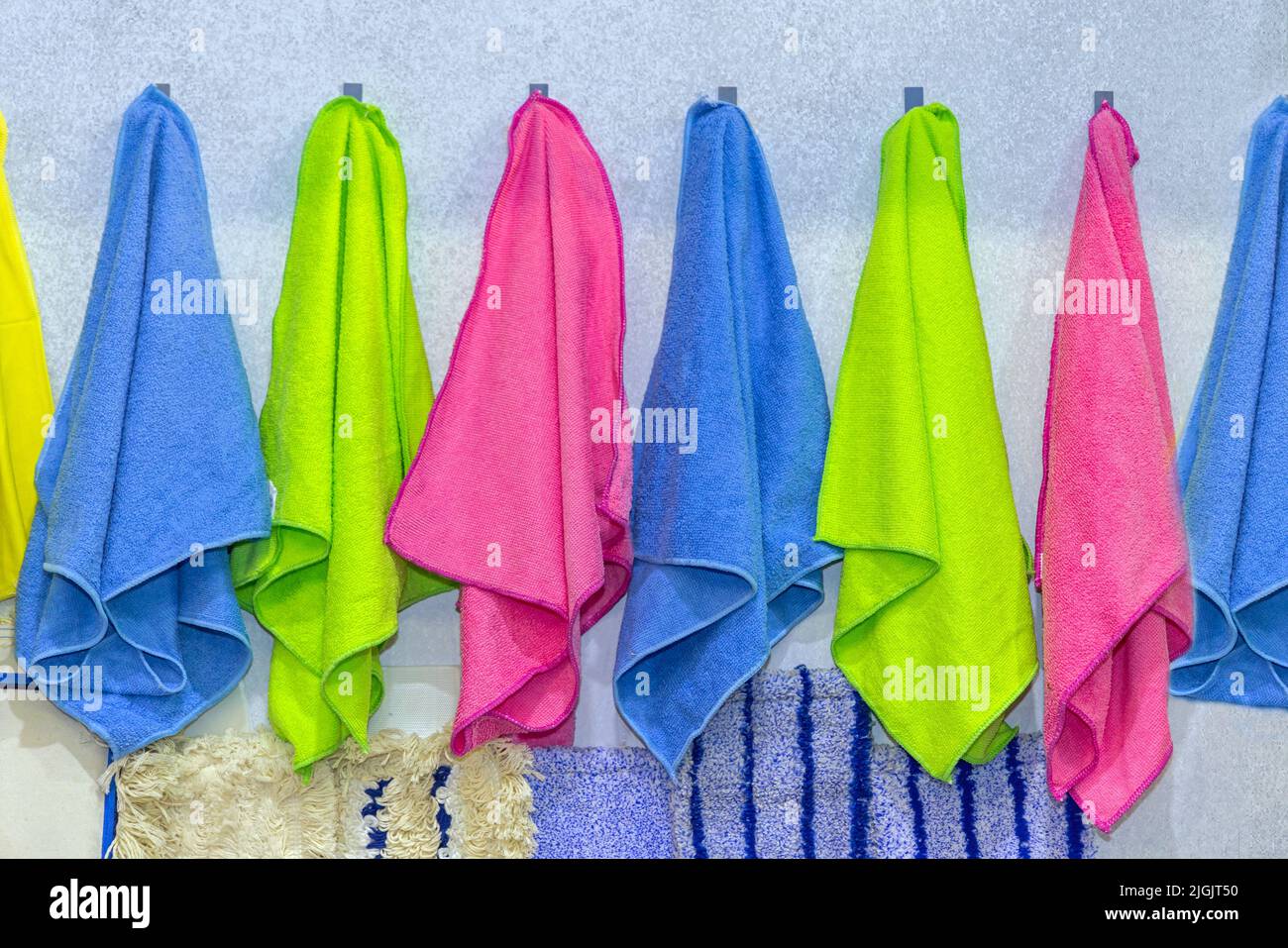 Lebendige Farben Mikrofasertücher Handtücher Reinigungsausrüstung an der Wand Stockfoto