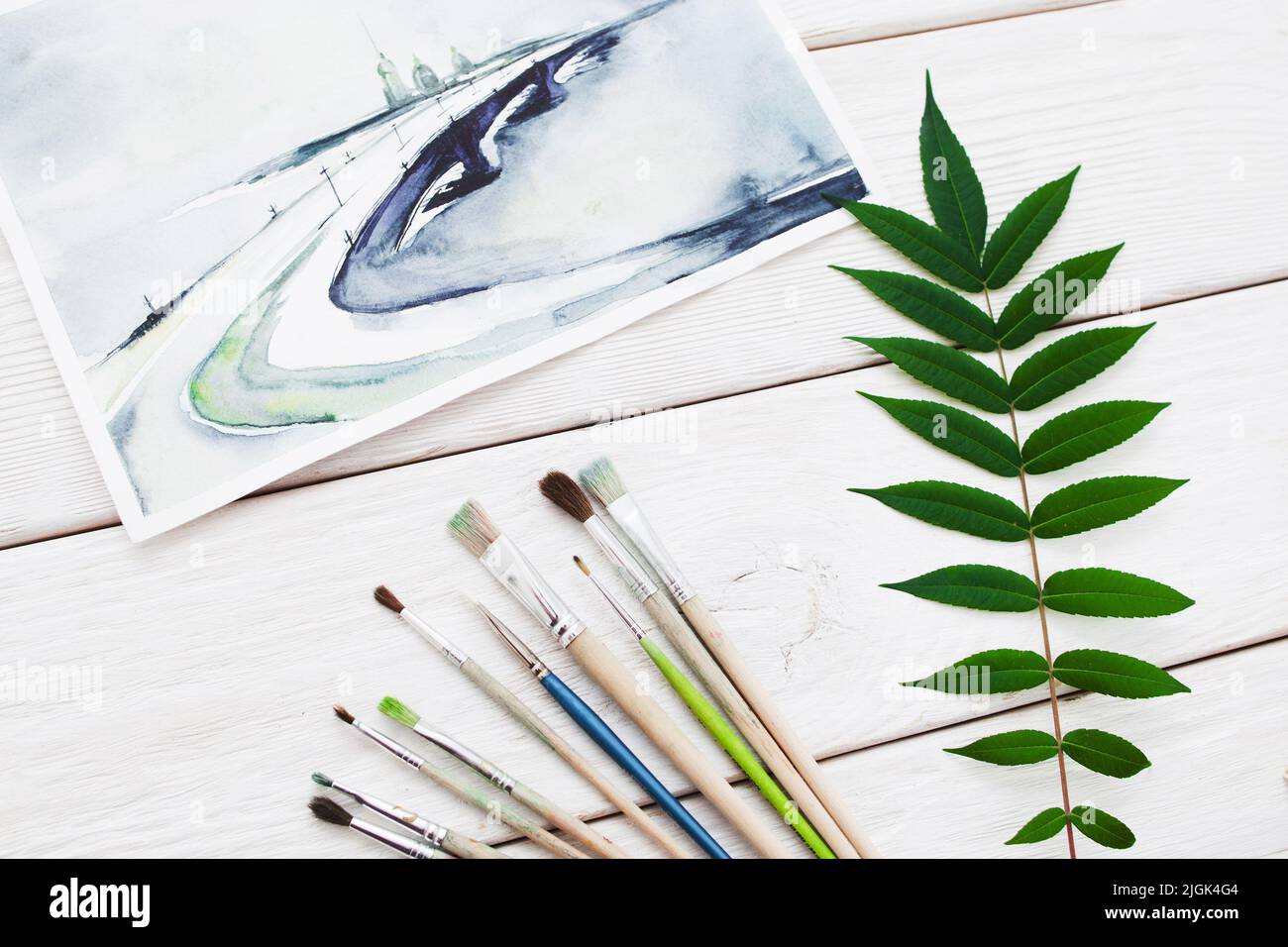 Aquarelle Landschaftsbild mit Pinsel und Blättern Stockfoto