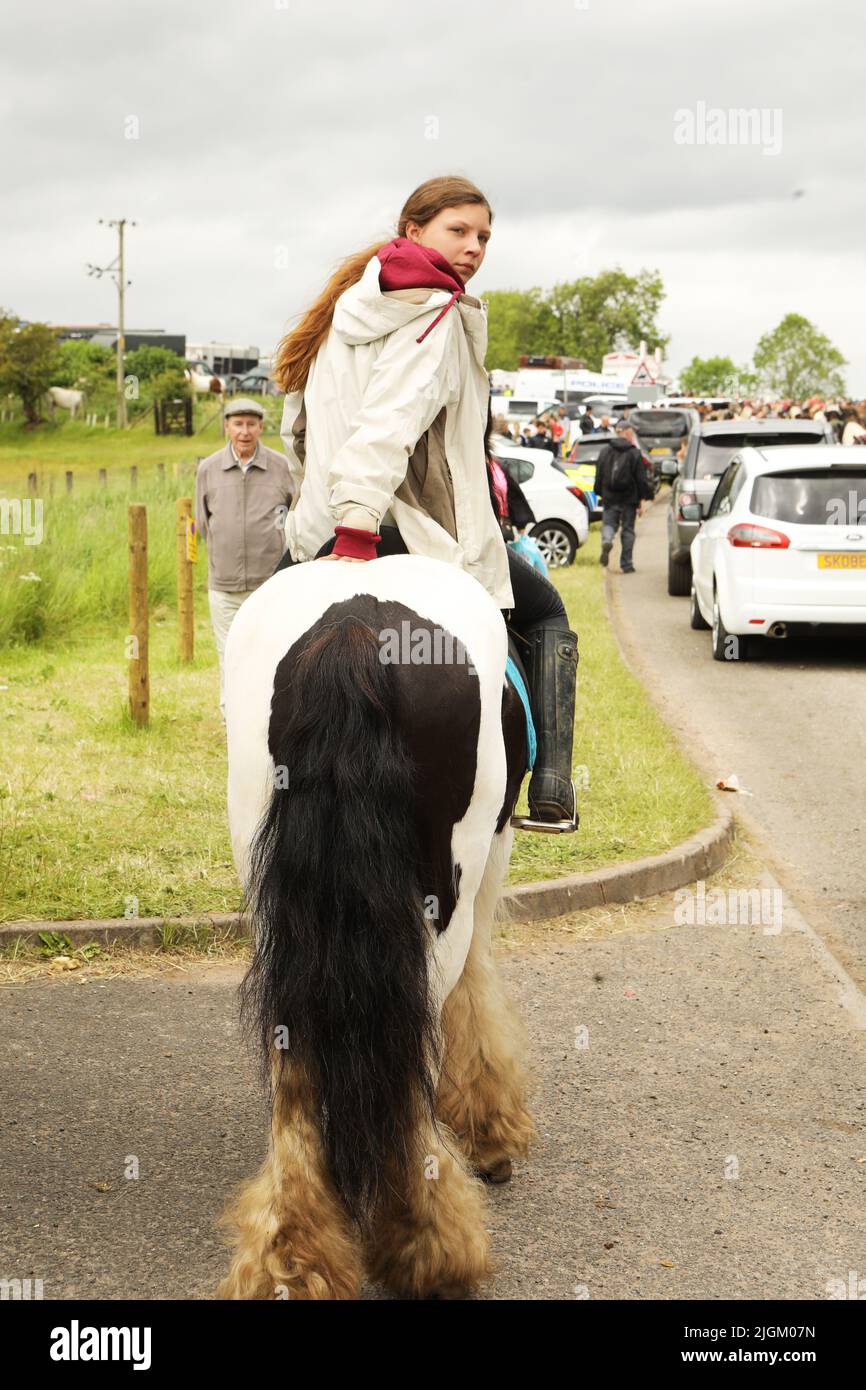 Ein junges Mädchen im Teenageralter, das auf einem farbigen Pferd reitet. Appleby Horse Fair, Appleby in Westmorland, Cumbria, England, Vereinigtes Königreich Stockfoto