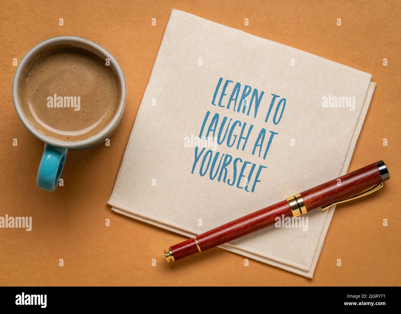 Lernen Sie, über sich selbst zu lachen inspirierende Notiz auf einer Serviette mit Kaffee, persönliches Entwicklungskonzept Stockfoto