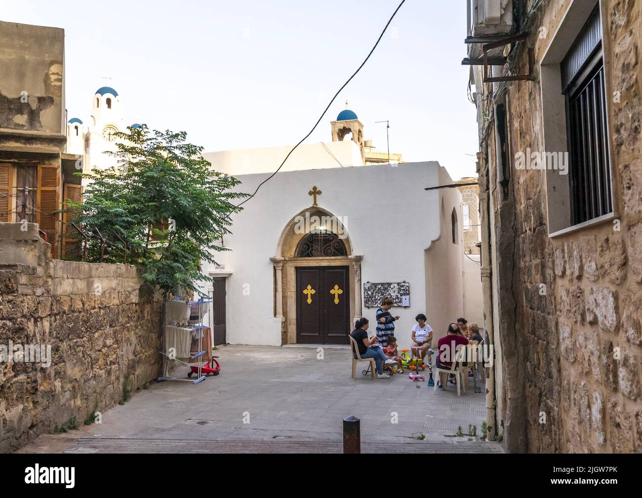 Menschen, die sich vor der griechisch-orthodoxen Kirche St. Georges, dem Nord-Governorat, Tripolis, dem Libanon entspannen Stockfoto