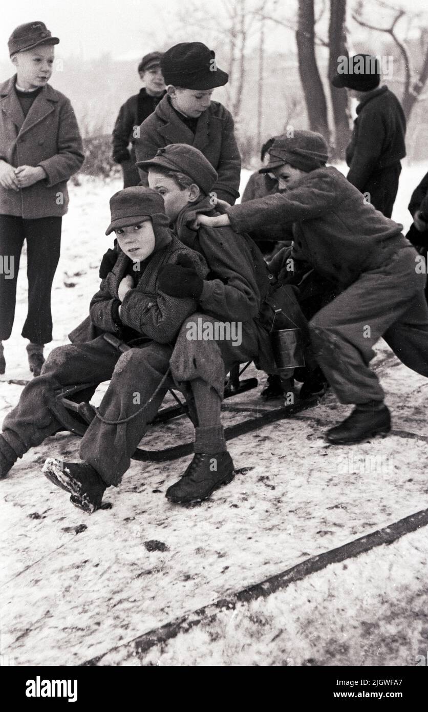 Trümmerfrau - Kinder spielen im Schnee im Berlin nach dem Krieg, Deutschland 1947. Stockfoto