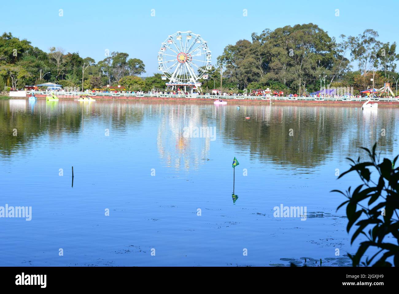 See mit Riesenrad im Hintergrund im Vordergrund Flaggen von Brasilien, mit Flaggen von Brasilien und Tretbooten, Brasilien, Südamerika, selektiver FOC Stockfoto